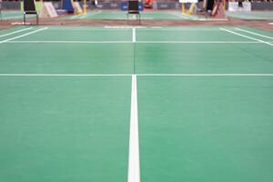 empty green used badminton court background is ready for playing badminton in competition or exercise for being healthy. photo