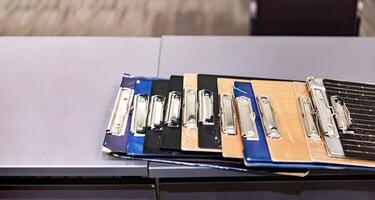 The referee Clip Board in the line was placed neatly on the table. Ready for badminton and table tennis competition photo