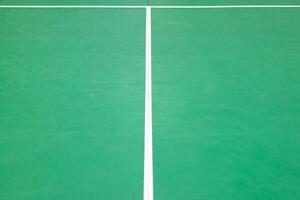 empty green used badminton court background is ready for playing badminton in competition or exercise for being healthy. photo