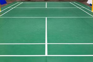 empty green used badminton court background is ready for playing badminton in competition or exercise for being healthy. photo