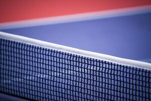 Blue and smooth surface table tennis table with tight black net to being prepared for practice and competition. photo