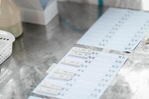 ATK results are place arranged on a paper number list on stainless silver table. photo
