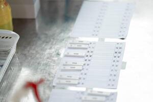 ATK results are place arranged on a paper number list on stainless silver table. photo