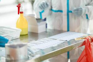 ATK results are place arranged on a paper number list on stainless silver table. photo