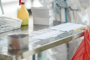 ATK results are place arranged on a paper number list on stainless silver table. photo