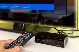 Digital decoder with remote control and television monitor. photo
