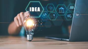 concept with innovation and inspiration, innovative technology in science concept and modern business development ,creative idea ,Businessman points at light bulb showing new idea ,problem solving photo