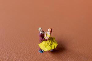 Couple dancing on a smooth brown background photo
