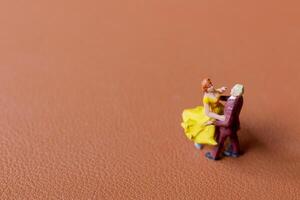 Couple dancing on a smooth brown background photo