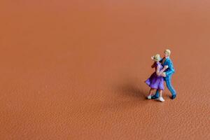Couple dancing on a smooth brown background photo