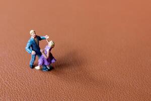 Couple dancing on a smooth brown background photo