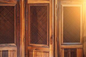 open wooden door with a lattice to the confessional for confession inside Catholic Cathedral photo