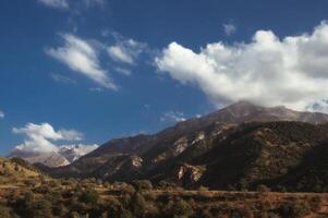 landscape with mountain peaks background the sky with clouds at sunset in summer photo