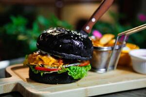 Black Burger With Fries and Dip photo