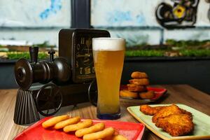 Beer and Snacks on a Table With a Clock photo
