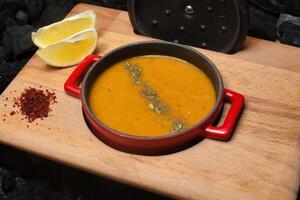 Red Pot of Lentil Soup With Lemon and Spices photo