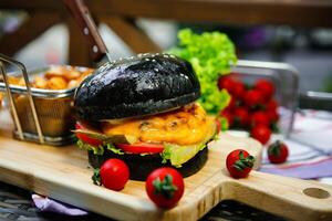 Black Burger on Wooden Cutting Board photo