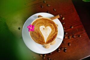 Heart-Shaped Latte With Cinnamon Sticks photo