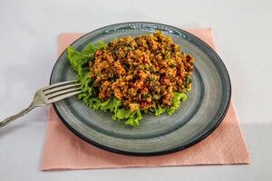 Bulgur Salad With Lettuce and Tomatoes on a Plate photo