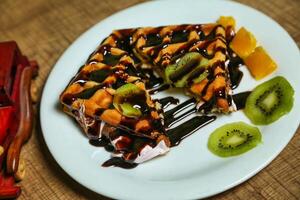 Chocolate Waffle With Kiwi and Orange photo