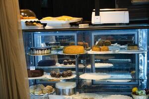 Bakery Display Case With Cakes And Pastries photo