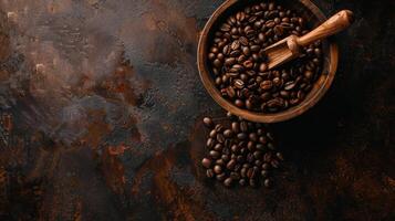 A wooden bowl of coffee beans rests on a dark textured surface photo