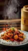 Close-up of a plate of orange chicken with rice, steaming on a wooden table photo