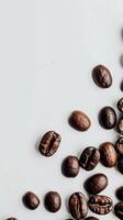 Close-up of coffee beans scattered on a white surface photo
