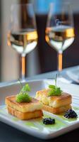 Two cheese and caviar toast pieces on white plate with garnish photo