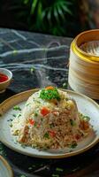 A plate of fried rice with parsley garnish, steaming on a dark surface photo