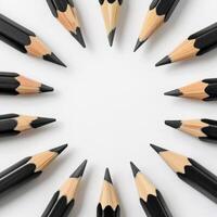 Black pencils arranged in a circle on a white background photo