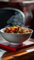 A white bowl of steaming stir-fry rests on a red coaster photo