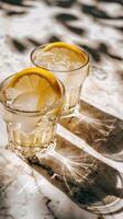 Lemonade in glasses with lemon slices and ice photo