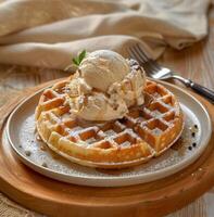 A waffle topped with ice cream and caramel photo