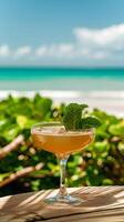 A refreshing mint cocktail in a stemmed glass on a beachside table photo