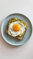 Avocado toast topped with a perfectly poached egg photo