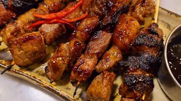 Beef Satay marinated with spice and sweet soy sauce, locals called it Satay Maranggi coriander beef satay, served on plate with onion, chilli, soy sauce and tomato. Indonesian food video