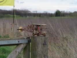a small model airplane on a fence post photo