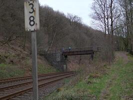 Mountain bikers on a bridge over railroad tracks photo