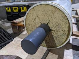 Inspection Water Ultra Filtration Membrane skid Maintenance. A close-up view of a water filter cylinder, featuring a white outer layer and a gray inner tube. photo