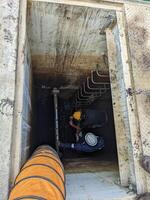 Two Workers Inspecting a Pipe Inside a Concrete Structure Confine space photo