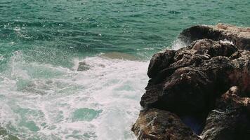 Waves crashing on rocks form dynamic seascape captures waves crashing against rocky shore highlighting power and beauty of nature Waves crashing create ever changing mesmerizing coastal view video