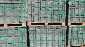 Pallet with paving slabs, block stacks used as building material at site Slabs neatly palletized ready for construction Footage shows various slabs organized efficiently for ease of transport and use video
