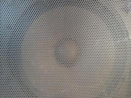 Radio speaker grid texture pattern, rough surface of a radio speaker, texture background, close-up photo