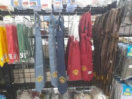 Lombok Island, Indonesia - July 6, 2024 - A colorful display of school tie placed on a shelf at a stationery store for public schools in Indonesia. photo