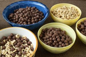 Set of various cereal bowl for breakfast. Corn rings with chocolate and cereal. photo