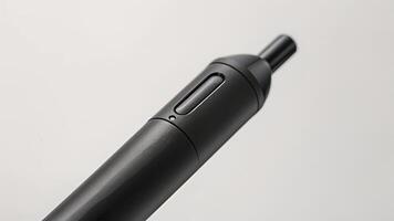 The tip of a smart pen is captured in detail showcasing its precision and fine point. The charging port is visible at the top of the pen right below the click button video