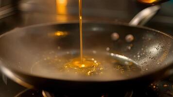 Avocado oil being poured onto a hot skillet creating a sizzling sound as it hits the surface video