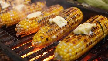 A simple yet enticing picture of grilled corn on the cob smothered in a generous amount of vegan butter video