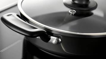 Closeup of the lid handle on an electric skillet showing its heatresistant design and comfortable grip for safely checking on the dish while cooking video